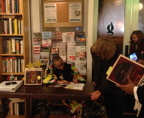 Andrea Davis Pinkney signs copies of her book for eager attendees while the storm rages outside. 