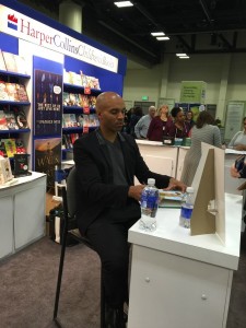 Kadir Nelson autographs copies of his books.