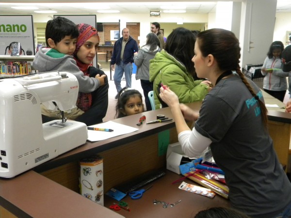 A family exploring sewing basics at Piscataway Library.