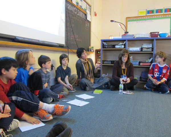 Baskin (center, with scarf) speaks to Mt. Kisco fourth-graders. Polos is to her right. 