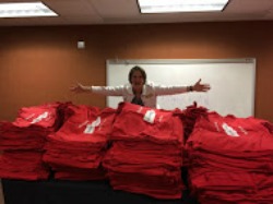 The author presides over the piles of shirts for distribution. 