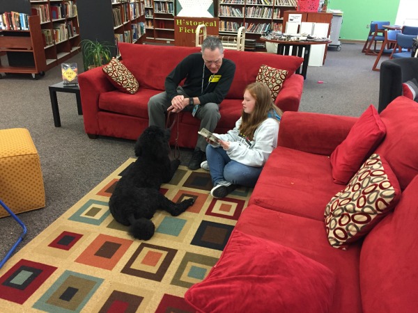 Standard Poodle Remy and his handler, Zane, coach a student through a tough passage.