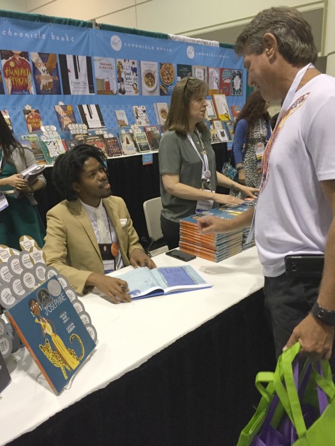 Christian Robinson signing copies of The Dazzling Life of Josephine Baker at the Chronicle Books booth