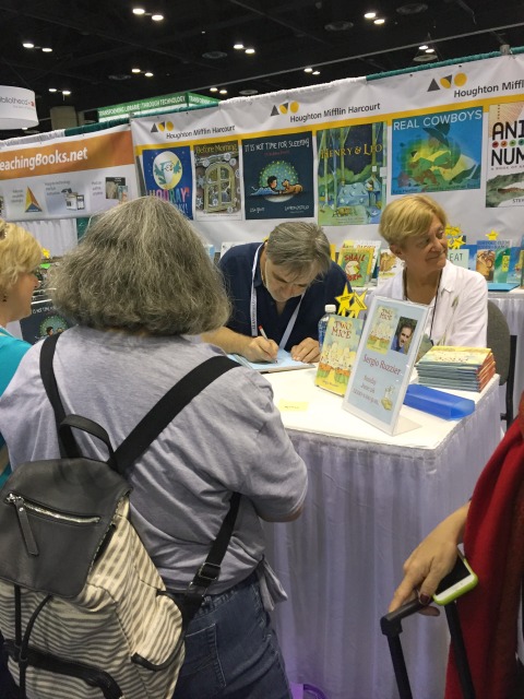 Sergio Ruzzier, intent of getting a message just right in a copy of Two Mice at the Houghton Mifflin Harcourt booth. 