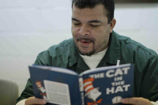 Rosario D. reads to his child. Photo courtesy of Brooklyn Public Library.