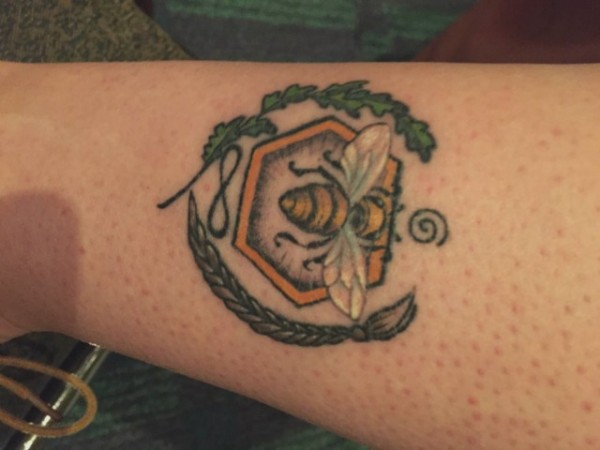 April Witteveen, community and teen Services Librarian with the Deschutes Public Library in central Oregon. The bee is for Bone Gap; the oak leaves and braids for Out of Darkness; the infinity and spiral symbols represent Ghosts of Heaven.