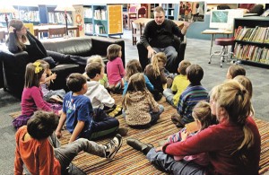 Burleson reads a picture book to first graders. Courtesy of Todd Burleson/ Hubbard Woods School