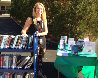 Hauer shows off her mobile book station at an outside event.