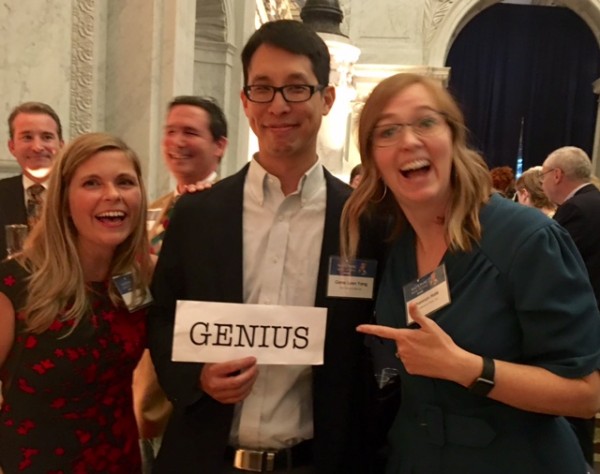 Jo Knowles and Shannon were busted trying to stick a sign to Gene Luen Yang's back.