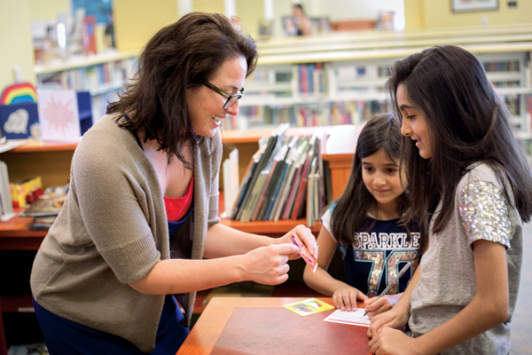 Children’s librarian Lindsay Jensen (left) at the Nashville Public Library, which has a strong children’s world language collection. Photo courtesy of Nashville Public Library Foundation
