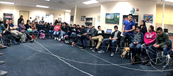 During the town hall meeting, the ball of yarn makes it way around the room.