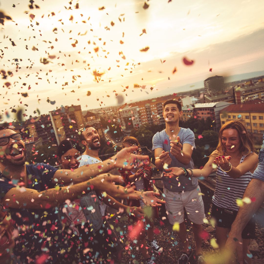 friends shooting confetti to celebrate the life of a loved one