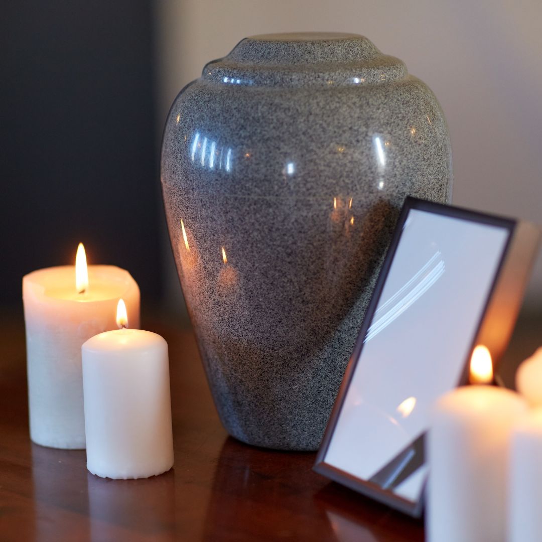 An urn surrounded by candles
