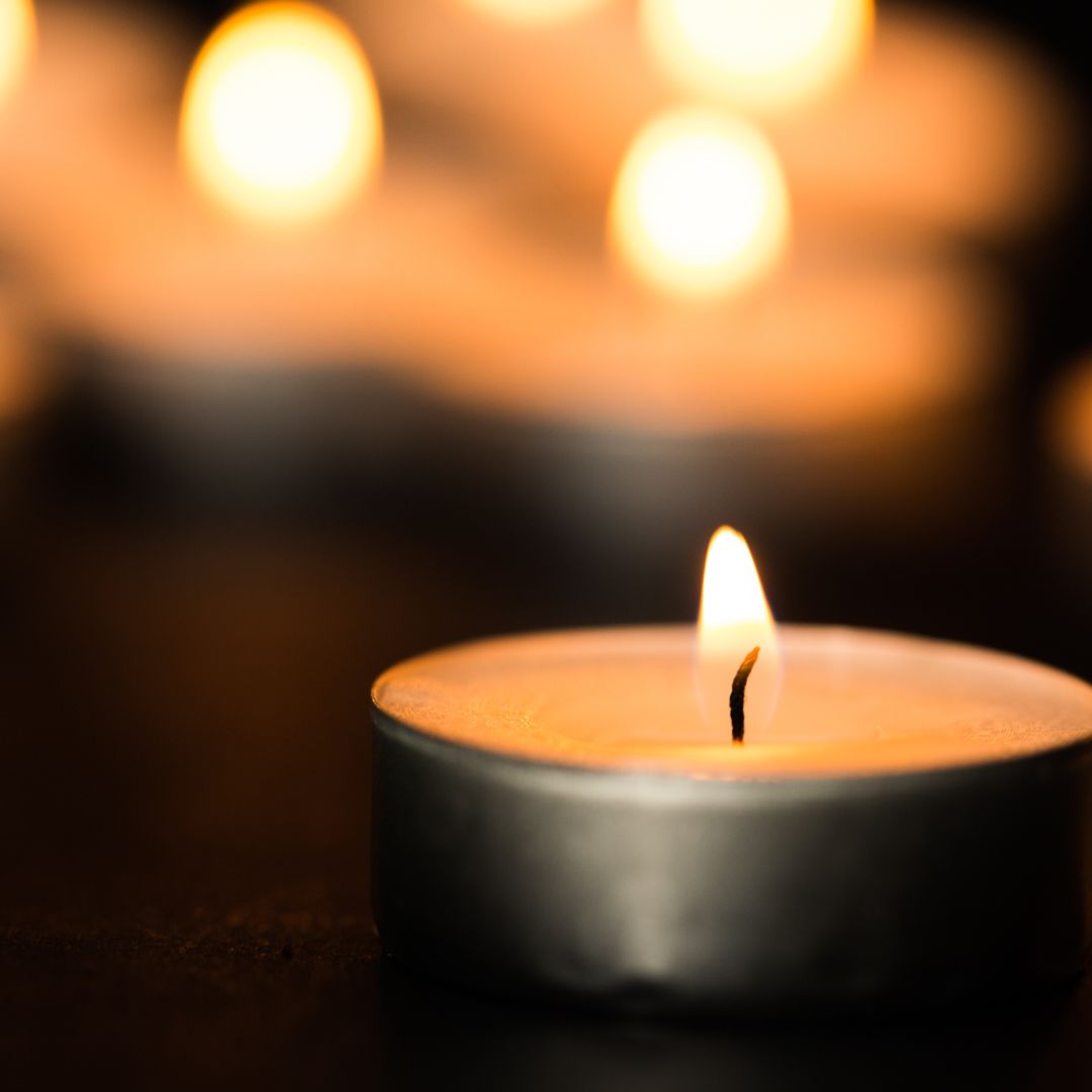 lit votive candle close up photo