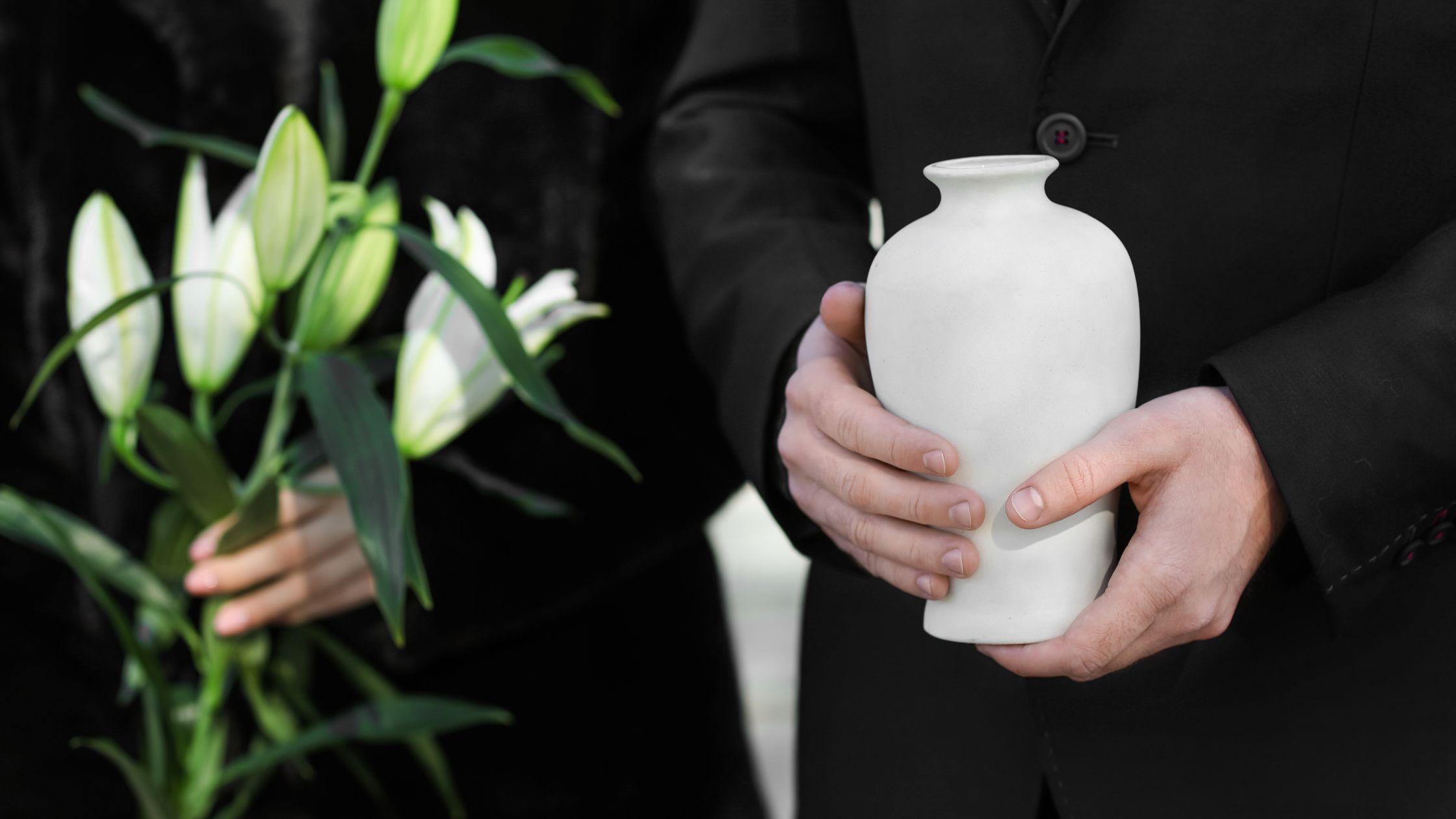 A man holding an Urn