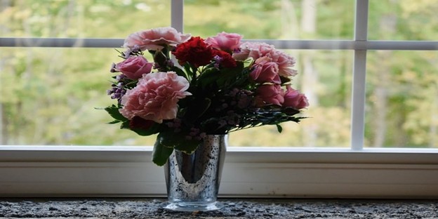 Floral arrangement near a window at a funeral service in Manville, RI