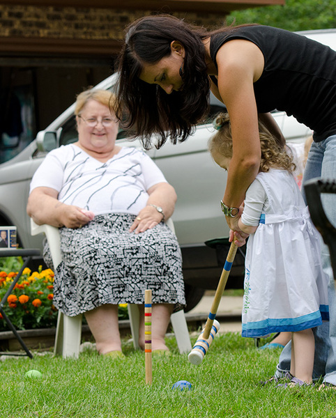 Aunt Mary Lou watching her niece and grand niece play in the yard.