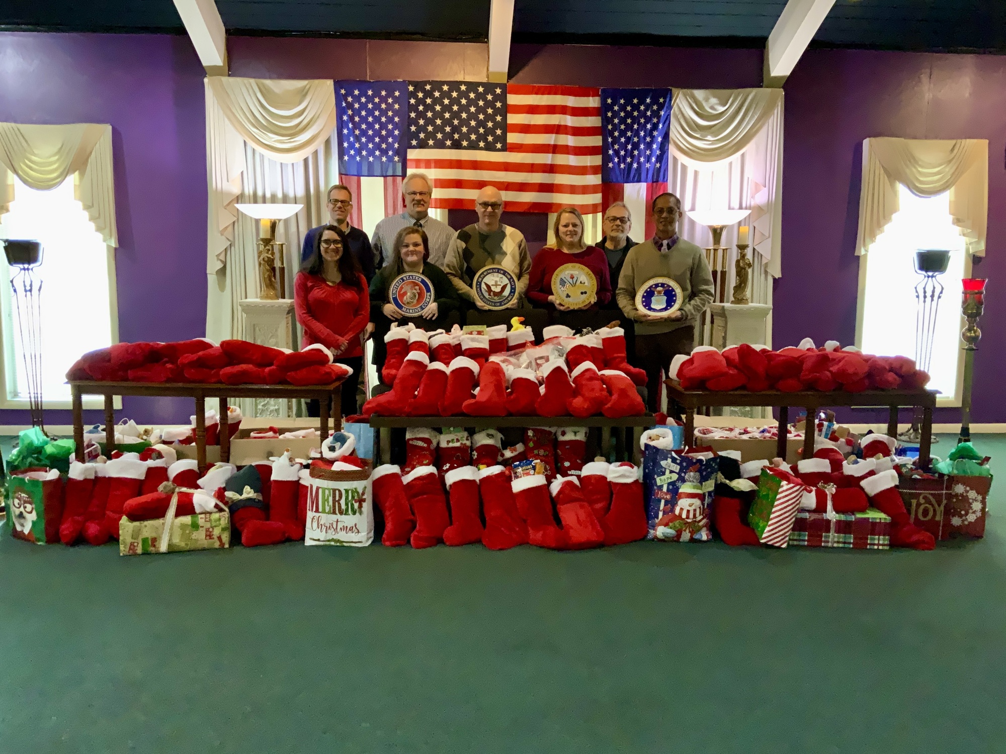 The Billings staff surrounded by nearly 200 stockings for veterans