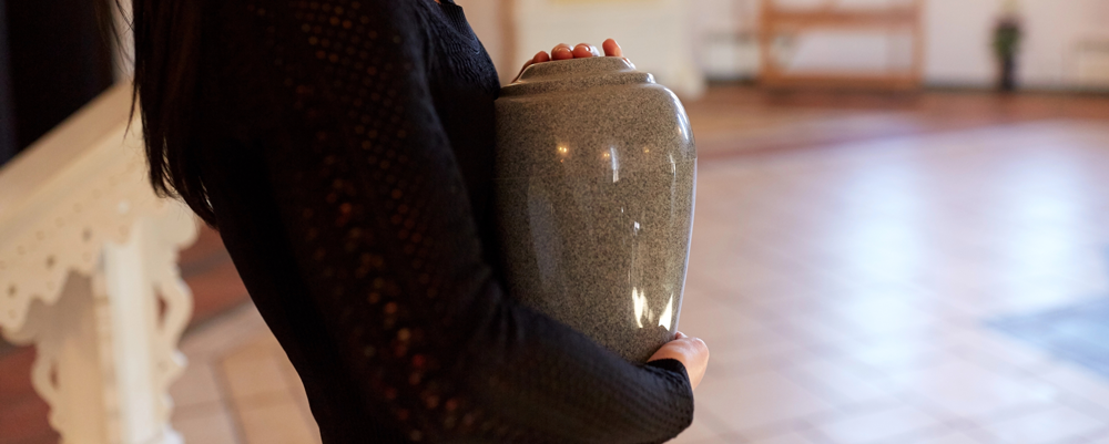 woman holding affordable cremation urn