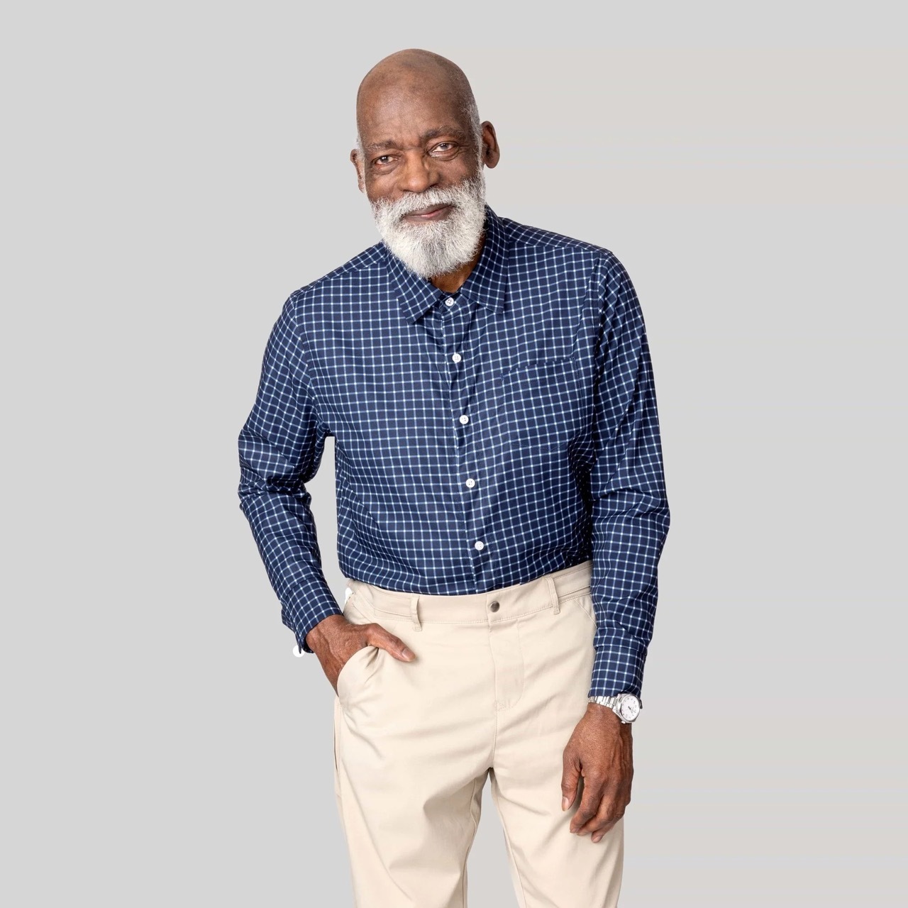 Man wearing blue checkered adaptive magnetic button down dress shirt and khakis