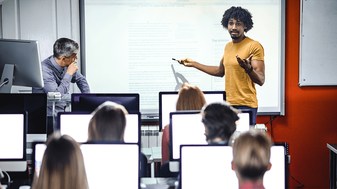 Person presenting in front of a college classroom