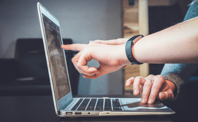 Someone Pointing at a Laptop Screen