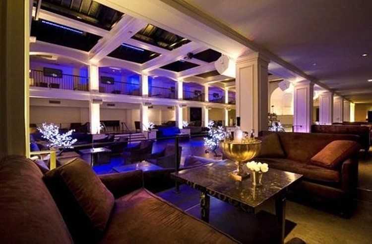 Luxurious and spacious nightclub interior at Boulevard3 Los Angeles featuring elegant lounge seating, ambient purple lighting, and sophisticated decor.