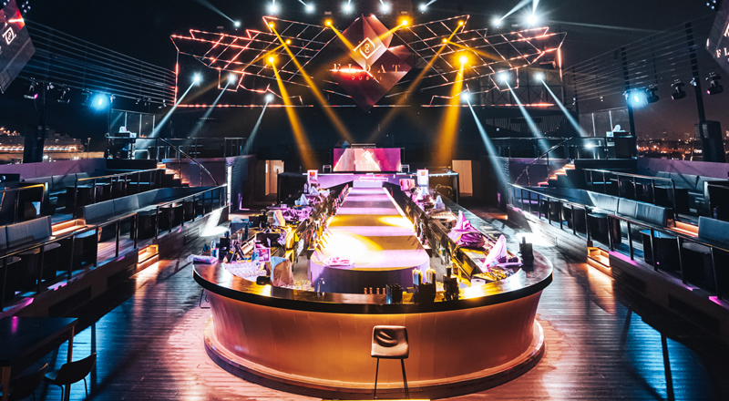 Night view of Float Dubai nightclub with vibrant lights, modern design, and an inviting dance floor.