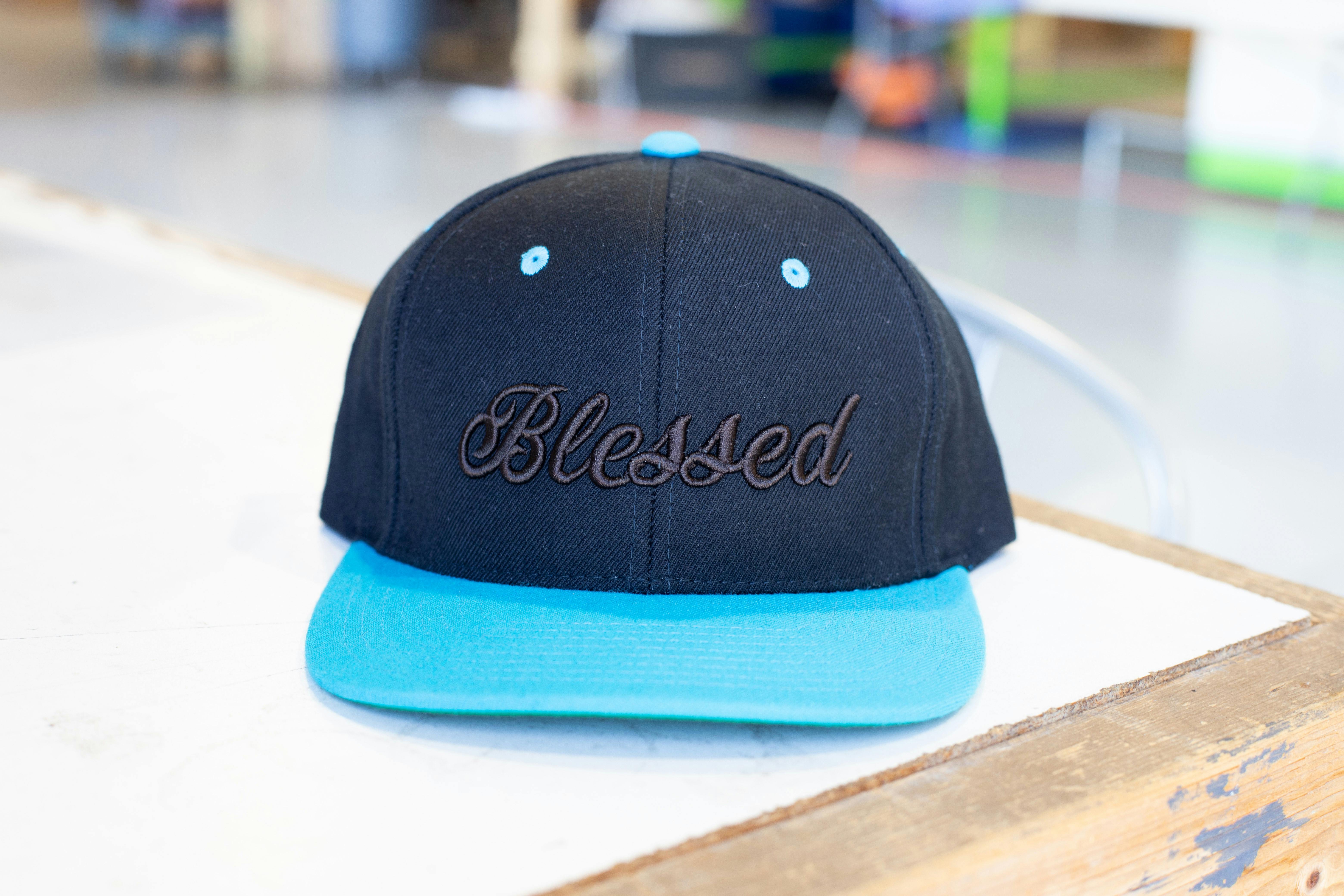 black hat with embroidery and light blue bill