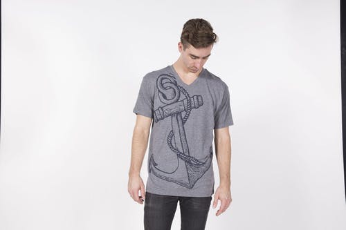 man wearing a gray shirt in a photoshoot
