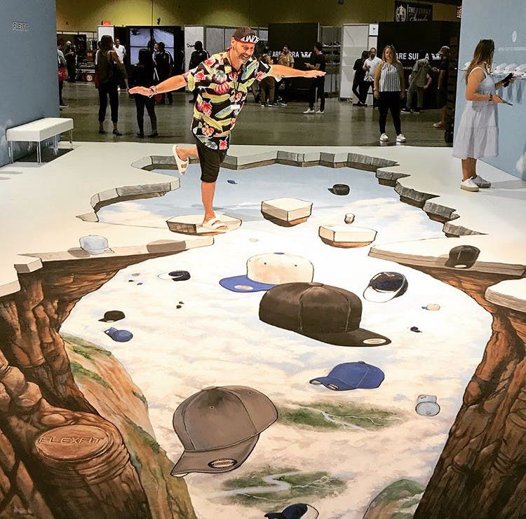 painted floor with rock walls on either side with hats fulling in the center