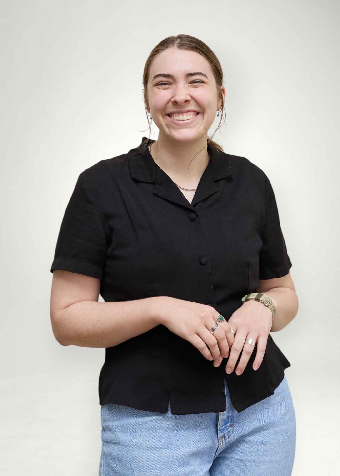 Tara poses in front of white background