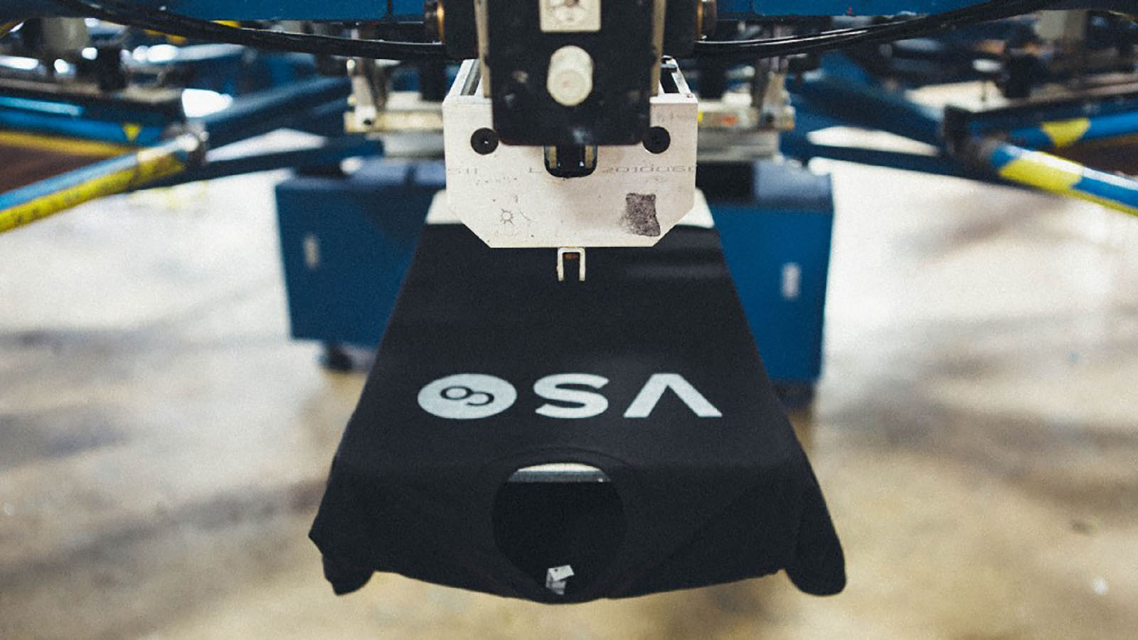 black t-shirt on screen printing press