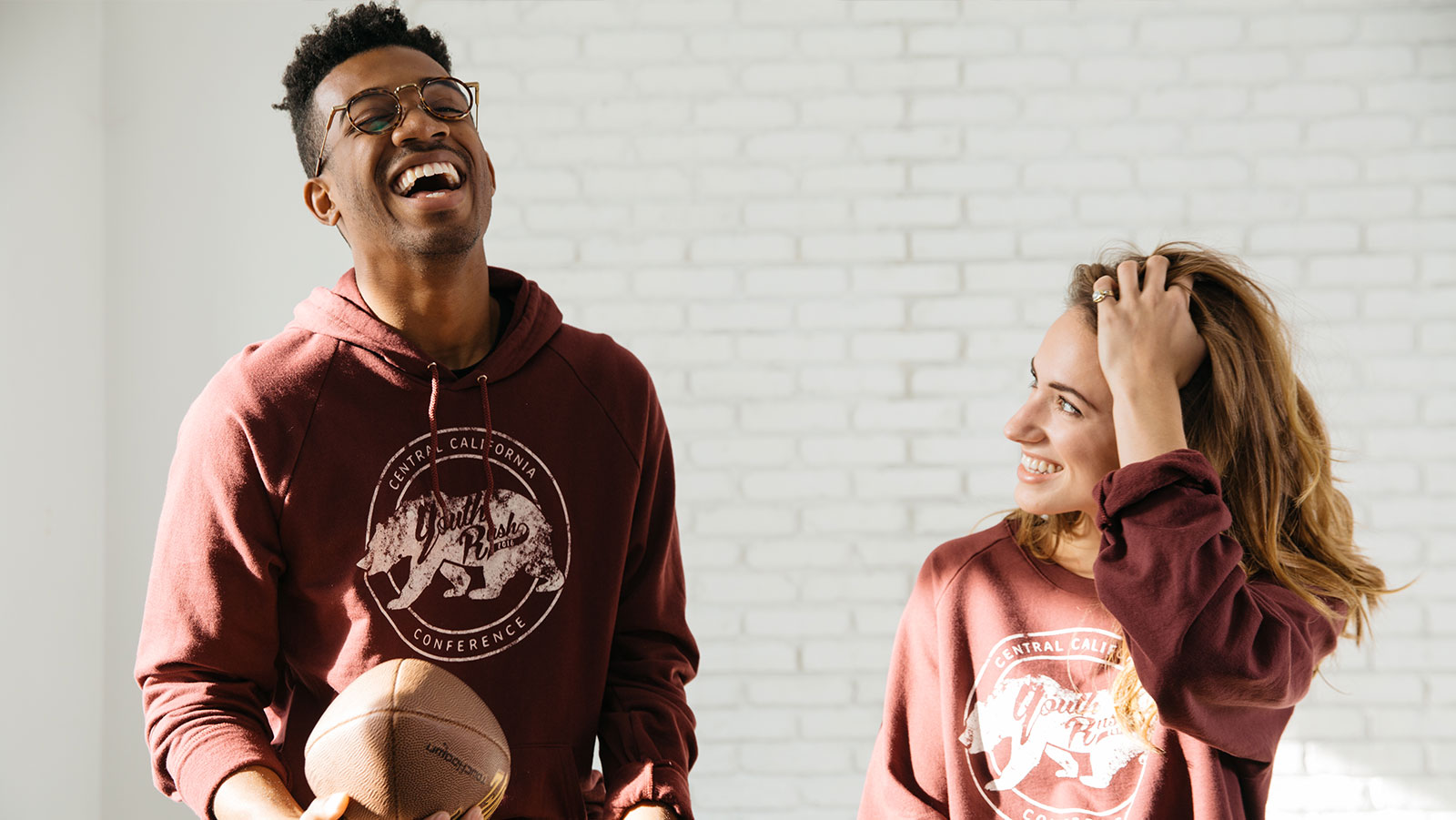 man and women wearing a red hoodie