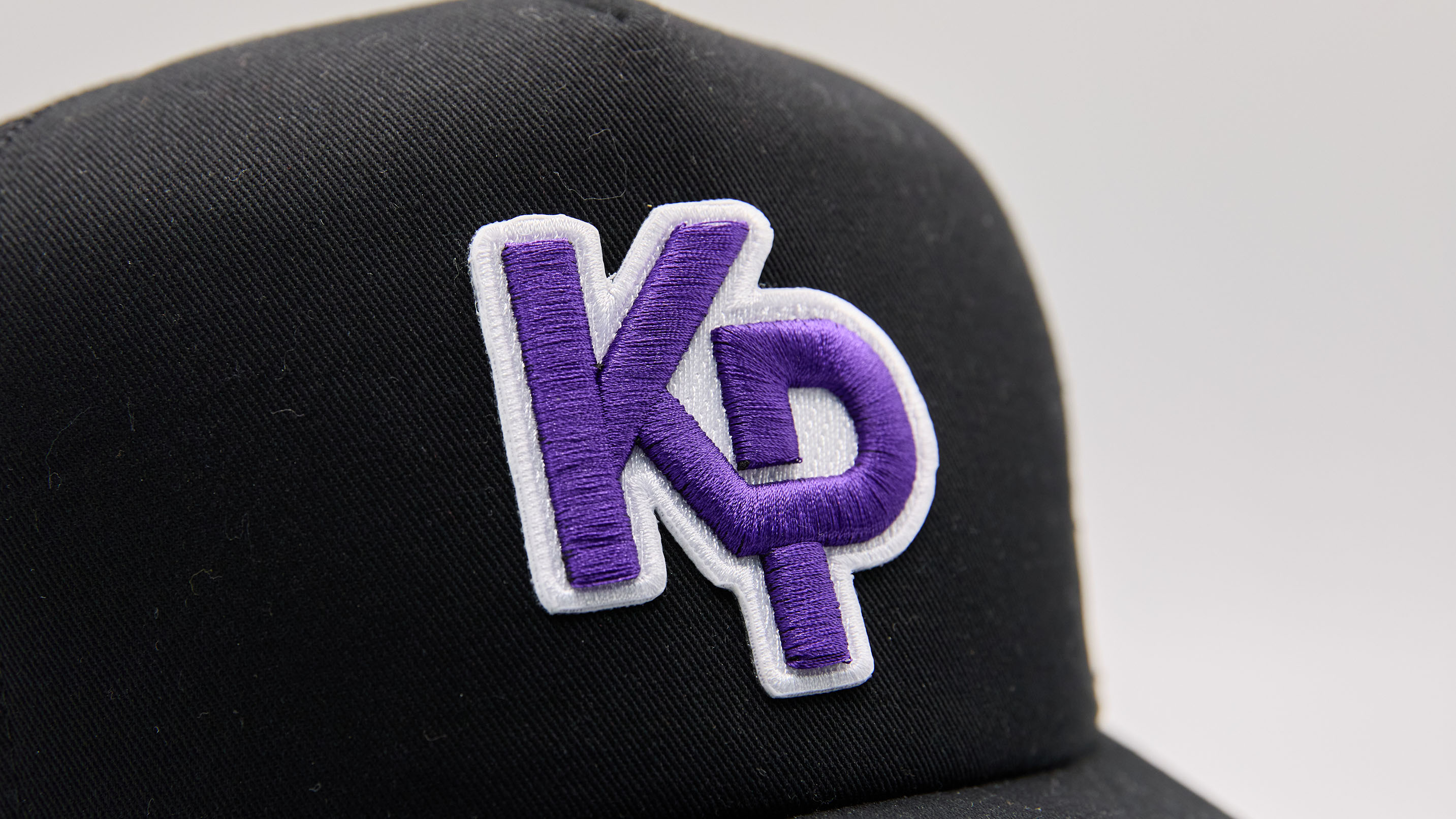 close up of a purple and white 3d embroidered patch