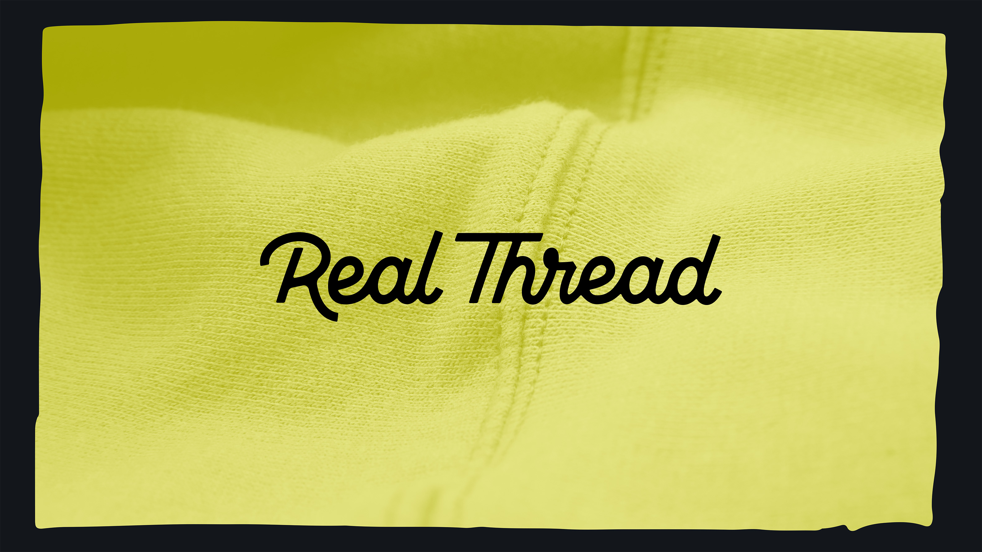 close up of yellow sweatshirt with real thread logo