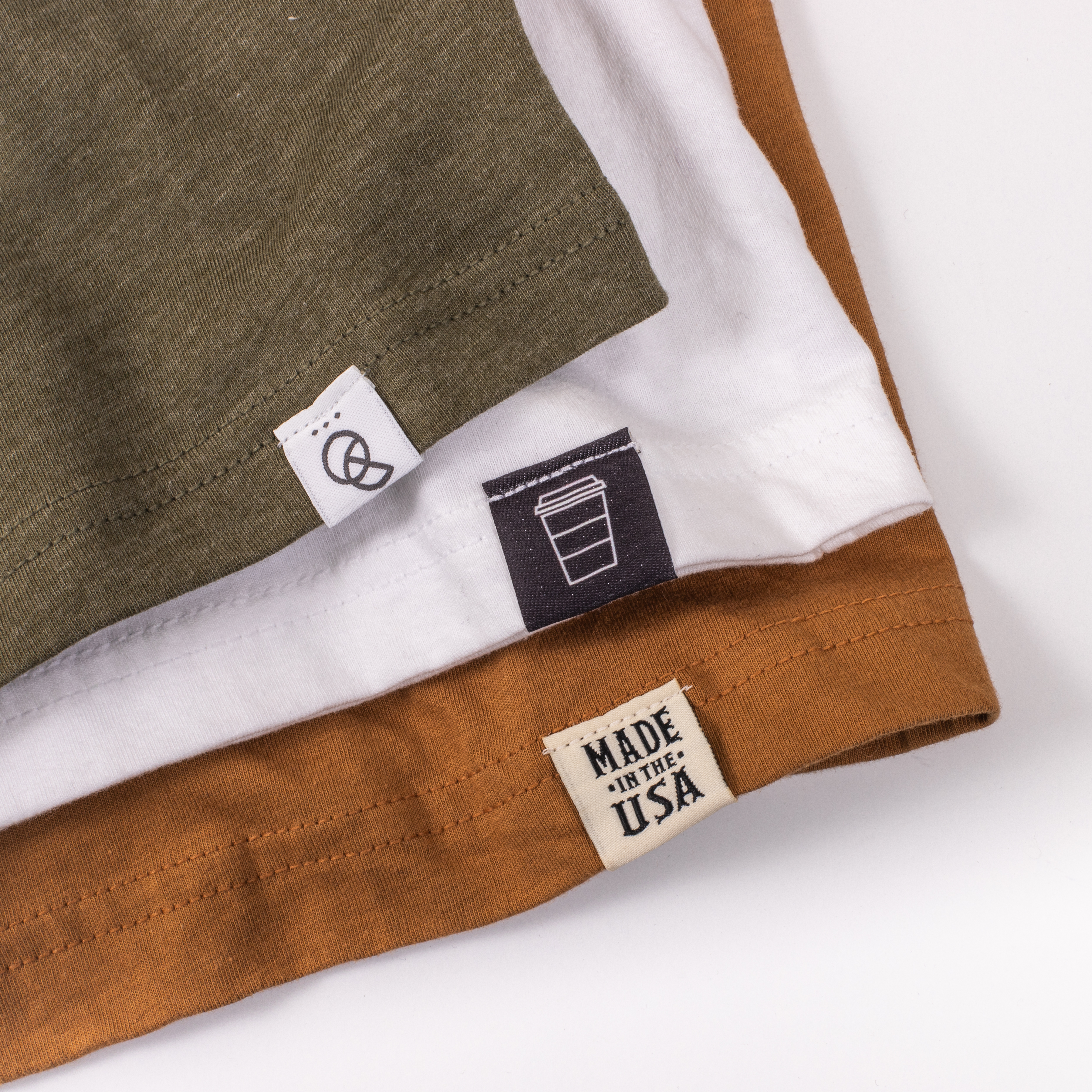 Three shirts with hem tags stacked up