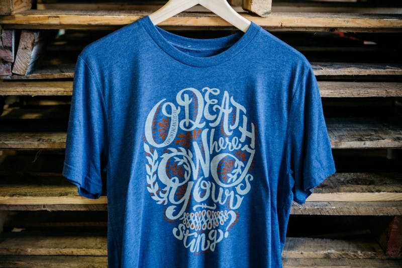 blue shirt hanging in front of a wood background