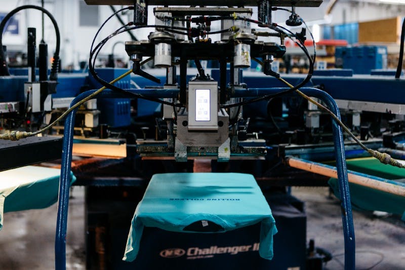 shirts on a screen printing press