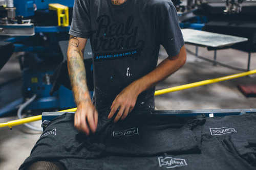 person folding t-shirts
