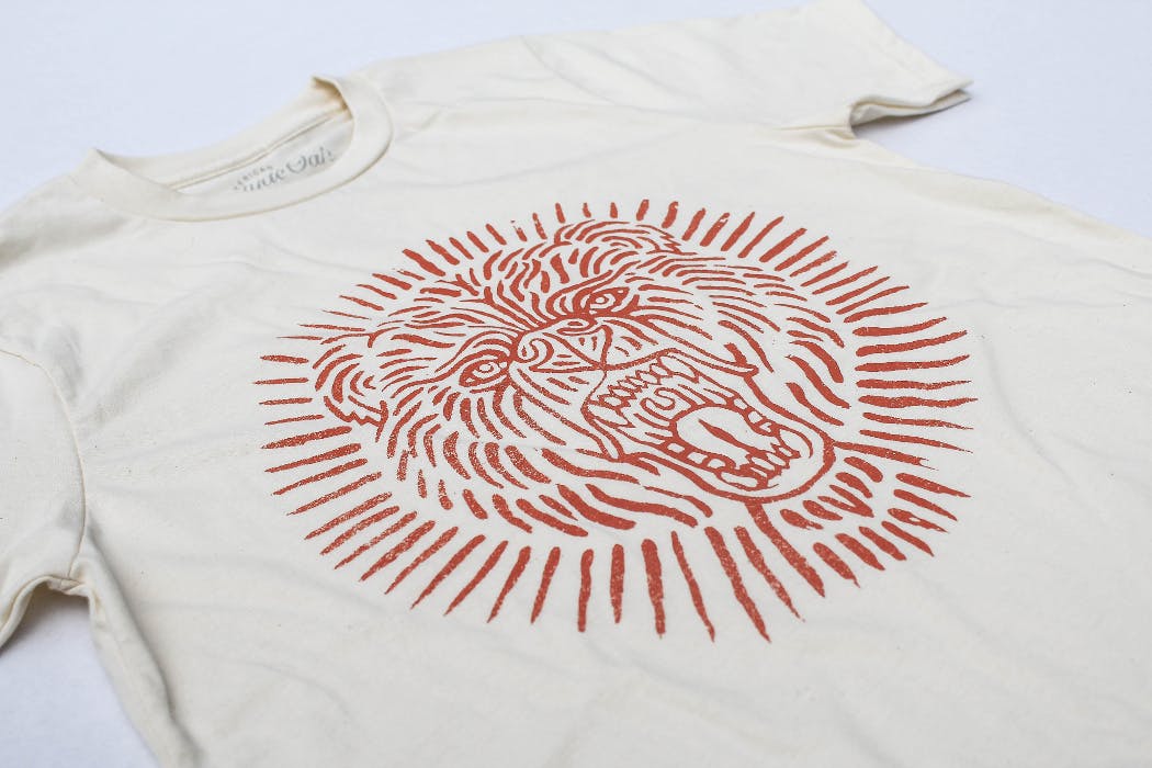 gray t-shirt with a red lion