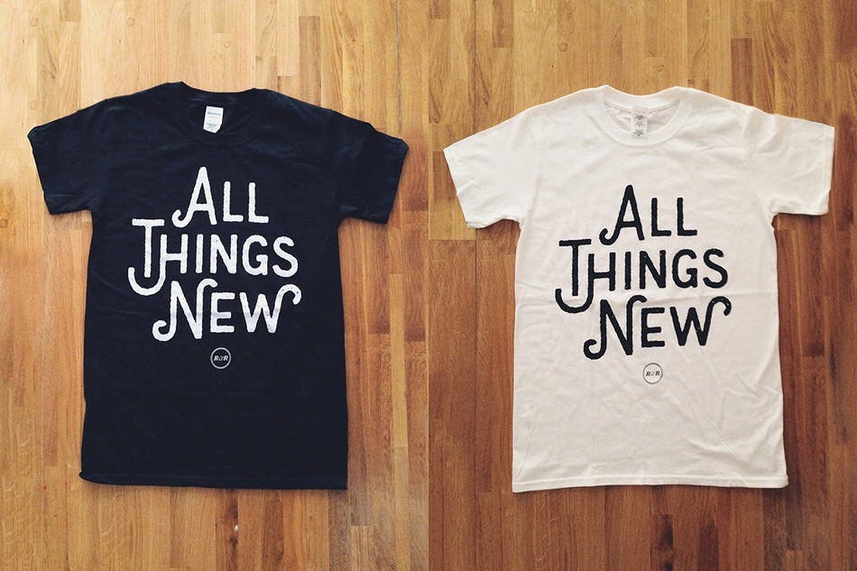 white and black t-shirts with all things news printed it