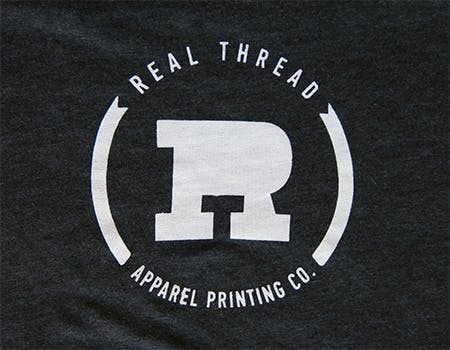 old real thread logo on charcoal fabric