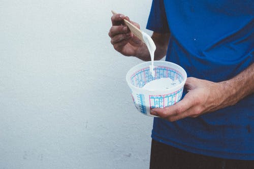 someone holding a container of ink