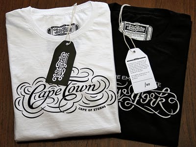 white and black shirts folded with cape town printed on them