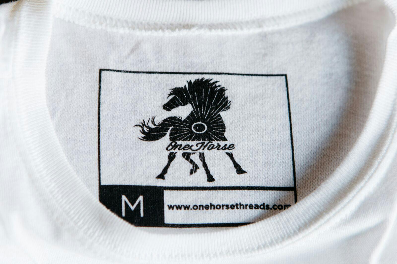 printed tag with a large outlined box with the logo inside