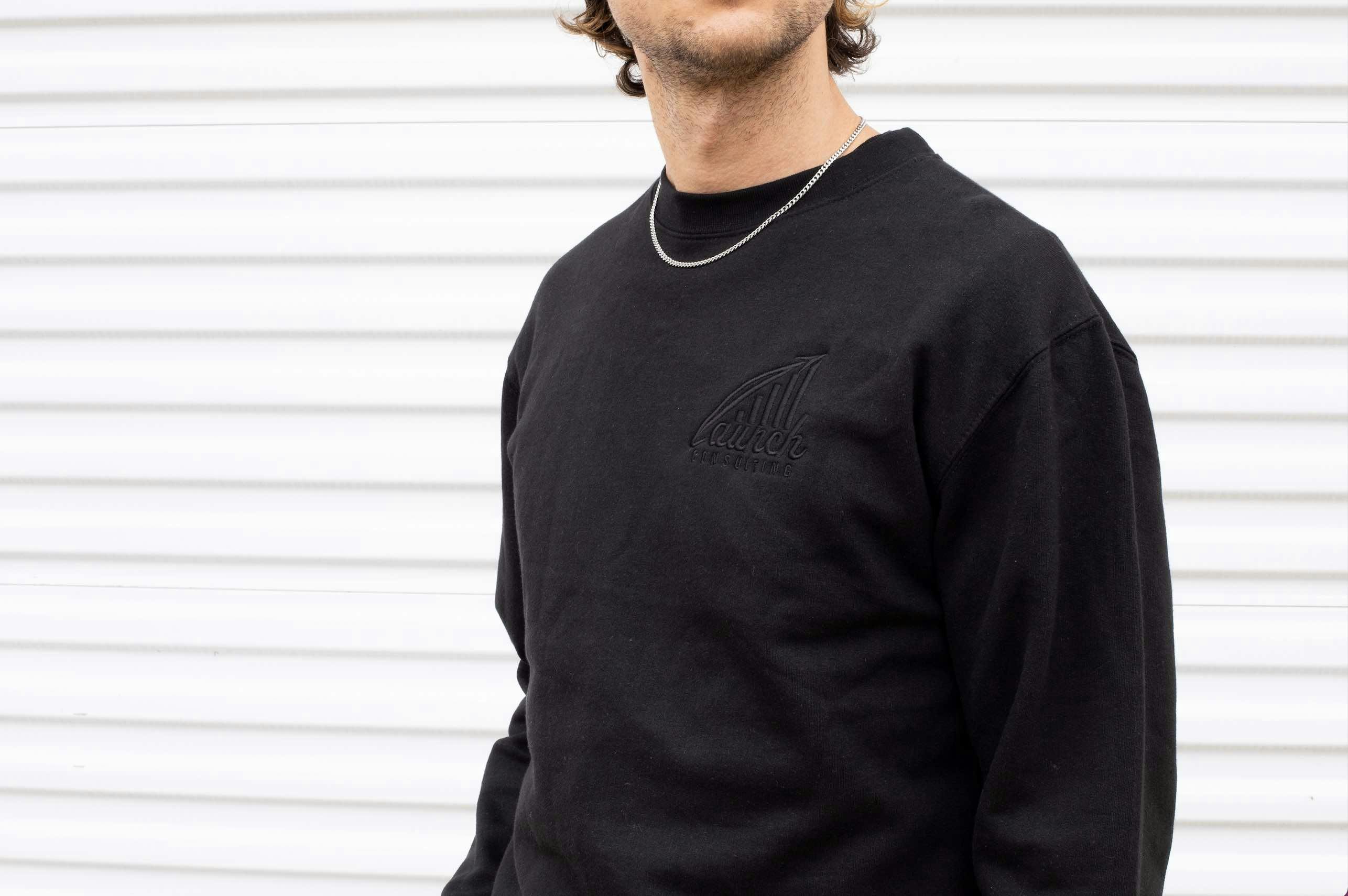 black crewneck sweatshirt with black embroidering