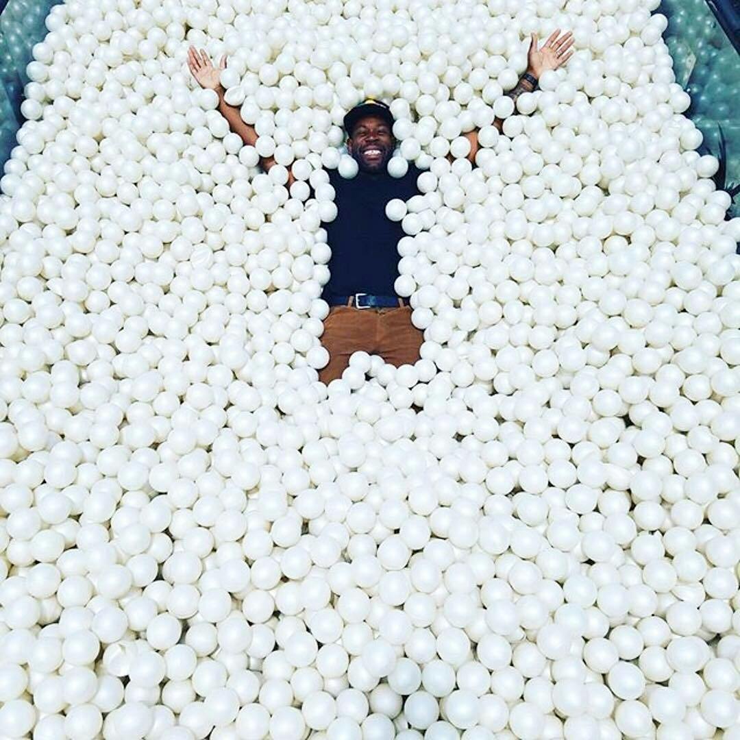 person in an all white ball pit