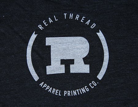 old real thread logo on tri blend black fabric