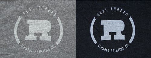 old real thread logo on light gray and black shirt fabric